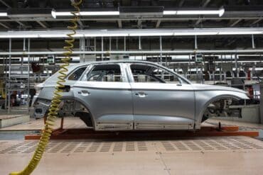 a car bring assembled in a standard auto industry factory