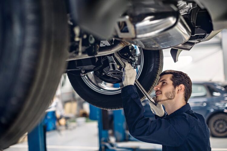 auto mechanic fixing car in repair shop