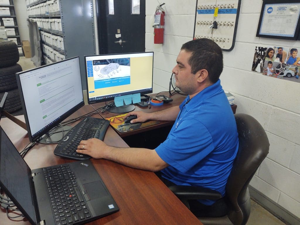 Jose Campos, asTech In-Shop Technician, at his computer.  