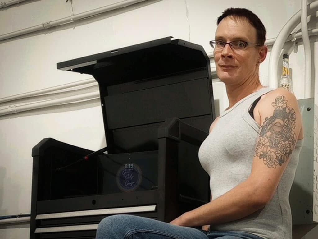 cc haug stands beside a toolbox in good judy garage